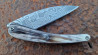 Couteau pliant Toltek lame damas Œil d'Odin et son manche en croûte de zébu de chez Mercorne
